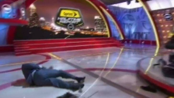 Man down: Shaq hits the canvas after becoming tangled in cables.