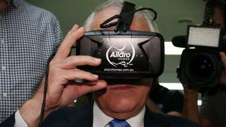 Prime Minister Malcolm Turnbull looks at real estate through virtual reality goggles. Photo: Andrew Meares