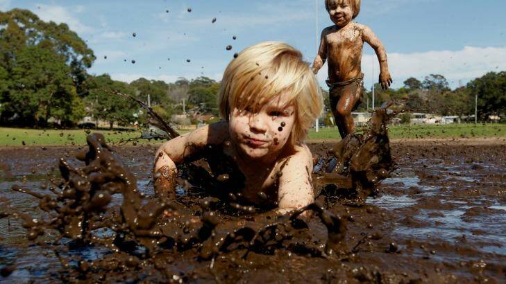 Slip and slide: Samuel, 2 and Gideon, 4, Waker celebrate the first day of spring. Photo: Steven Stewert