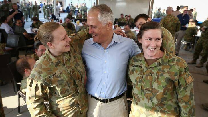 Prime Minister Malcolm Turnbull poses for photos with Lieutenant-Corporal Blaire Harris (left) and Private Georgia Gilbertson (right) during breakfast at Camp Baird ahead of his visit to Iraq. Photo: Alex Ellinghausen