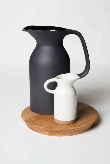 Perfect for serving, these exposed stoneware vessels are part of a new collection for Royal Doulton by acclaimed designers Edward Barber and Jay Osgerby. Wooden trivet, $49.95, large black jug $129, small white jug (part of a set) $89.95, myer.com.au. Photo: Supplied