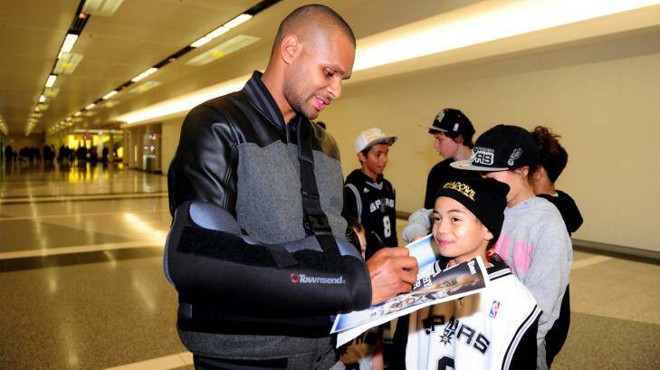 Patty Mills signs an autograph for Avari Petersen, 8, of Wright, at Canberra Airport. Photo: Melissa Adams