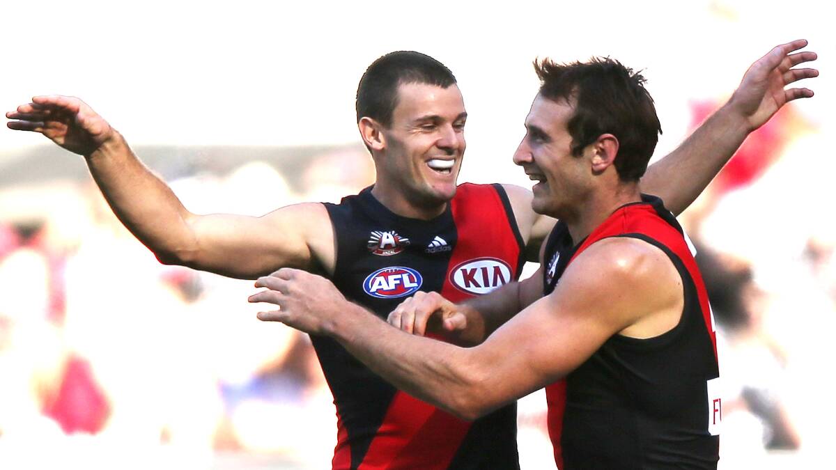Brent Stanton of the Bombers celebrates a goal with Jobe Watson. Photo: Getty Images.