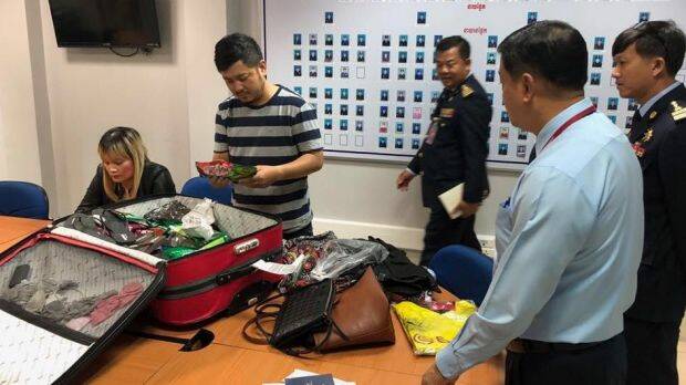 Police arrest an Australian woman allegedly with 1.8 kilograms of heroin hidden in a suitcase. Photo: Supplied
