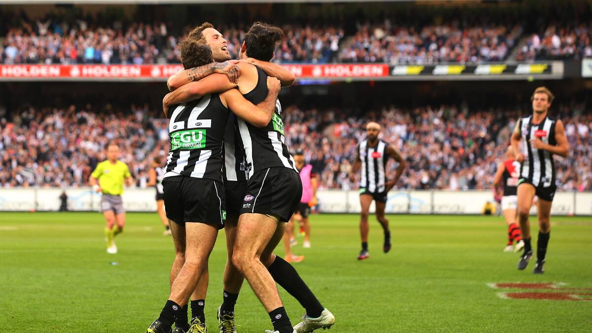Steele Sidebottom (L) Brent Macaffer (C) and Brodie Grundy of the Magpies. Photo: Getty Images. 