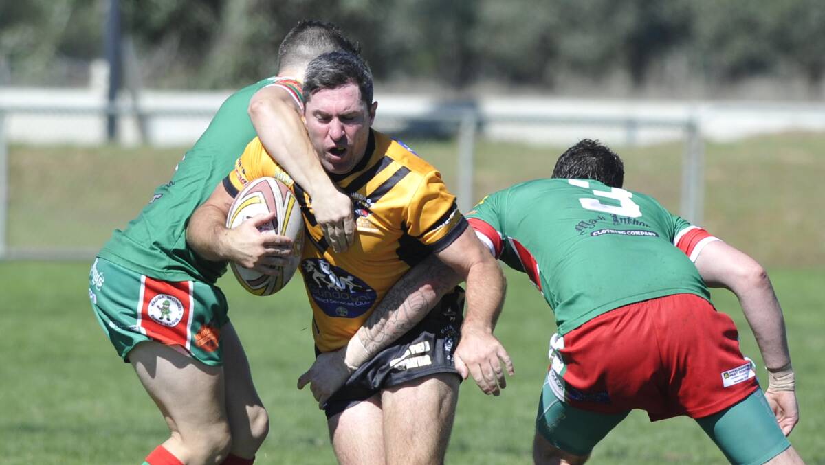 Group 9. Gundagai v Brothers. Gundagai's Mat Rose gets tackled by Brothers' Matt Morris and Ben Warner. Picture: Les Smith 