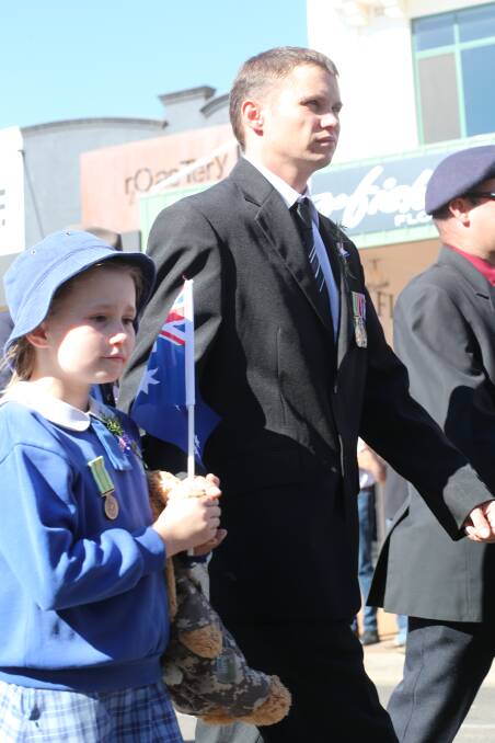 Anzac Day in Griffith. Chris Potroz is a returned solider from Afghanistan and marched with his daughter Maddison, 9. Picture: Anthony Stipo 