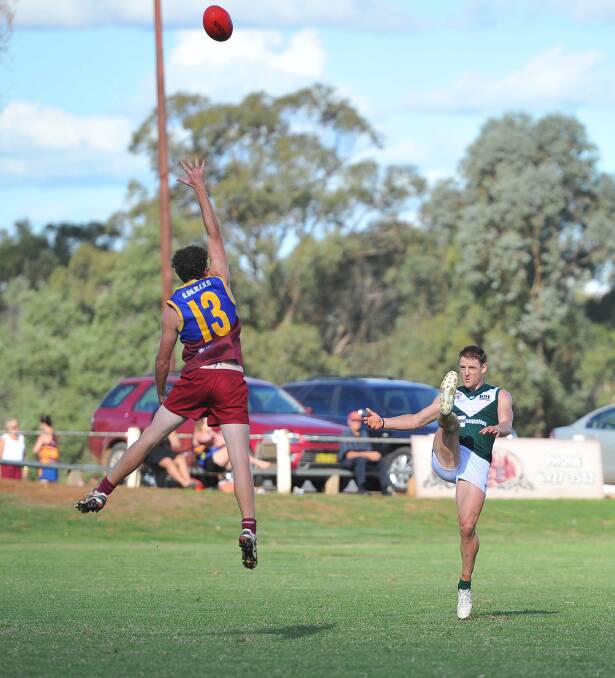 RFL. Coolamon v GGGM. GGGM's Andrew Clarke tries to stop a kick for goal by Coolamon's Lew Roberts. Picture: Kieren L Tilly 