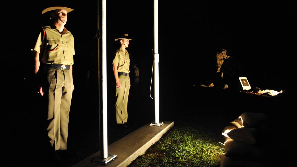 Dawn service at Kapooka. Members of the catafalque party Recruit Samuel Hitchenson and Recruit Kyle Arestia attend to the flag poles. Picture: Kieren L Tilly