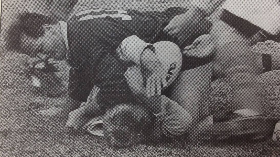 Andrew Strong of Deniliquin is crash tackled by an army opponent in the Leeton 10s Rugby Union carnival of Saturday.