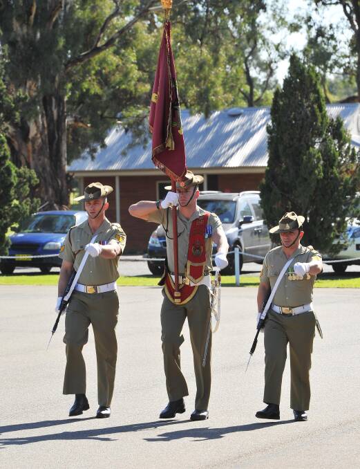 Anzac Day march out at Kapooka. The Governor General's banner enters the parade ground. Picture: Kieren L Tilly 