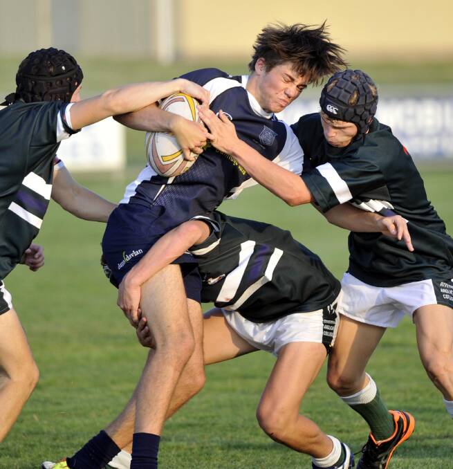 April 2. The Riverina Anglican College v Wagga High School. Wagga High's Nick Trevaskis is tackled by Luke Murray, John Downes and Jack Stubbs. Picture: Les Smith