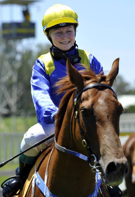 Apprentice jockey Brooke Sweeney, aboard Little Capri, is 
all smiles after handing her dad, trainer Phil Sweeney, a victory in the opening race of the Murrumbidgee Turf Club’s Australia Day meeting. Picture: Les Smith