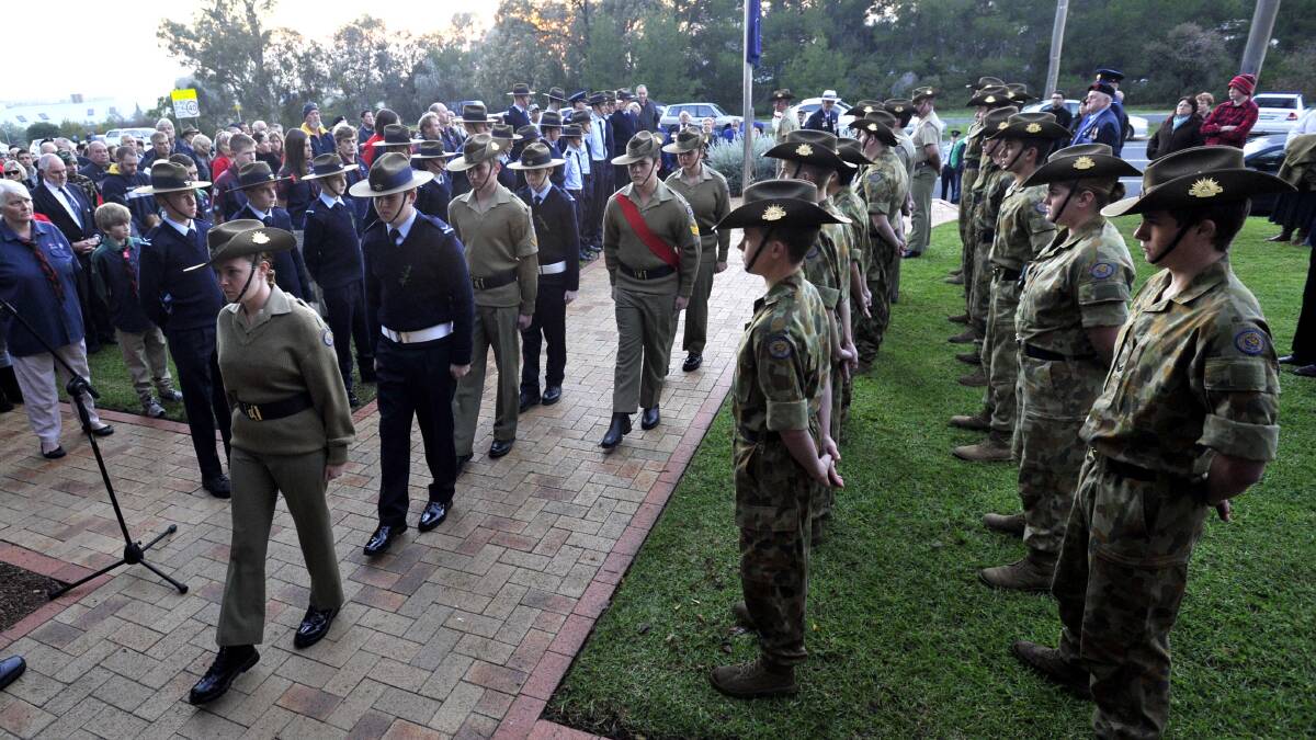 Dawn service at the war cemetery. The catafalque party makes its way to the memorial. Picture: Les Smith