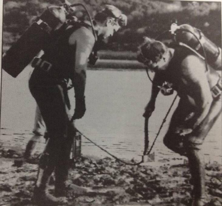 Police divers recover a small axe from the Greenough River as part of an investigation of the deaths of Karen ManKenzie, 31, and her 16-year-old son Danny and daughters Amara, 7, and Katrina, 5, on February 22, 1993 in Geraldton.