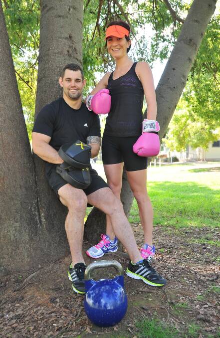 LOVE IS A BATTLEFIELD: Wagga fit2date ambassador Kayla White (right) and personal trainer Shoun Piper get ready before singles will be put through their paces at the fit2date mega meet on May 17. Picture: Kieren L Tilly