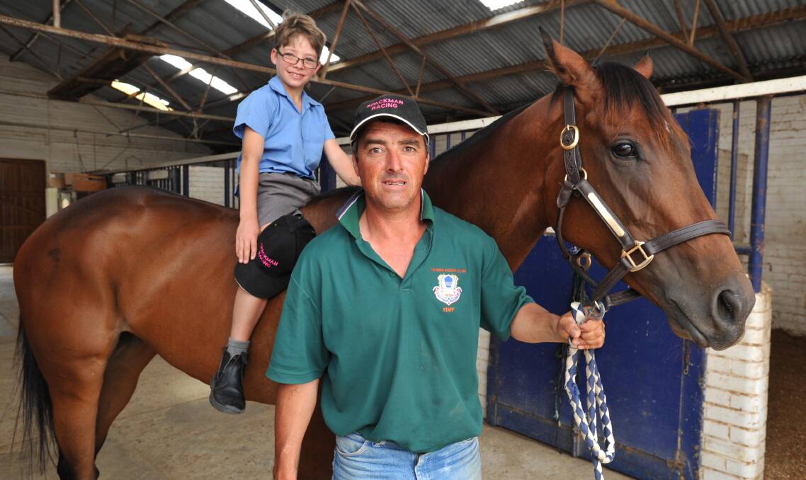 RATED: Scott Spackman and son Oliver with Yet Tobe Convinced at his Wagga stables. Yet Tobe Convinced in rated a $15 chance for the Country Championships Final next year. Picture: Michael Frogley