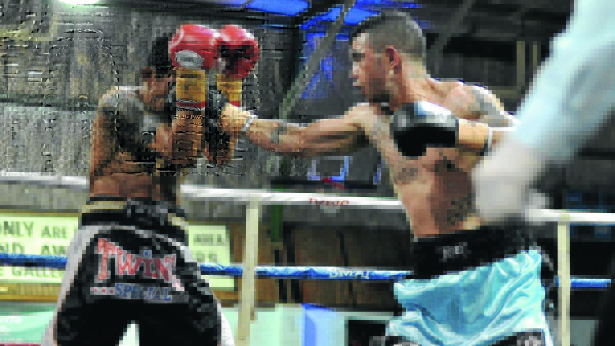 DEFENDING: Rusmin Kie Raha (left) tries to keep Joe Williams at bay during the world title bout on Saturday night.