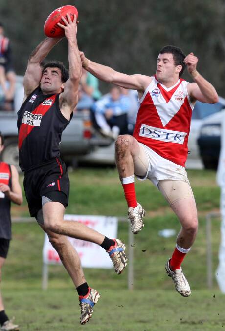 STRONG: Marrar is set to welcome back Brad Langtry for the upcoming Farrer League season. Langtry is pictured taking a mark in front of Collingullie's James Morris. 