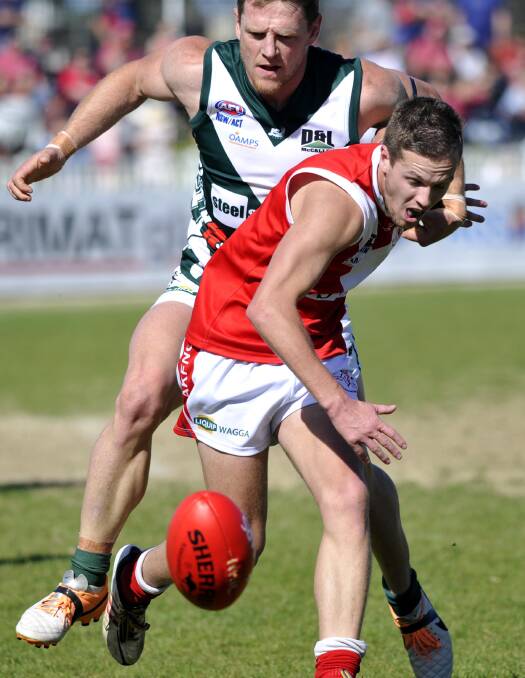 FINAL GAME: Coolamon coach Lew Roberts chases Collingullie-Ashmont-Kapooka defender Matt Lewington in Sunday's preliminary final at Robertson Oval. Picture: Les Smith