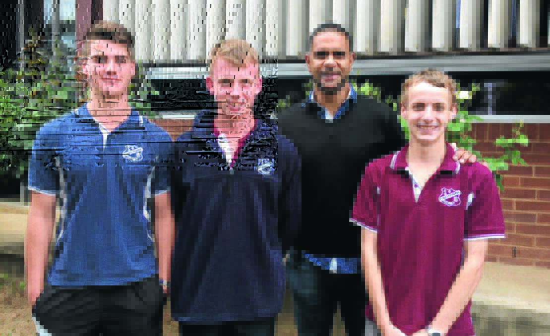 MEET AND GREET: Sydney Swans champion Michael O'Loughlin spends time with Tumbarumba High School's Zakk Stewart, Alex Crelly and Callum Wilson on Monday.