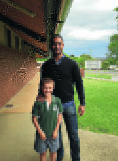 BIRTHDAY BOY: Sydney Swans great Michael O'Loughlin with birthday boy, Callum Jackson, 11, at Tumbarumba Public School on Monday.