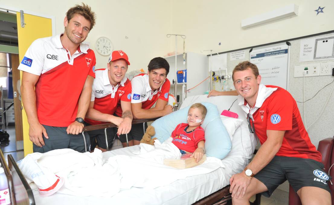CHEER UP: Sydney Swans players (from left) Nick Smith, Zac Jones, Lewis Melican and Harry Cunningham brighten the day of Steven Houting, 6, at Wagga Base Hospital's Children's Ward on Monday. Picture: Laura Hardwick