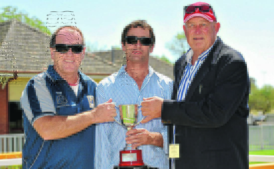 ALL SMILES: Men Of League's Stuart Raper, Canberra trainer Garry Kirkup and owner Greg Harris show off the Men of League Cup after Oh Lonesome Me's win at Wagga on Saturday.