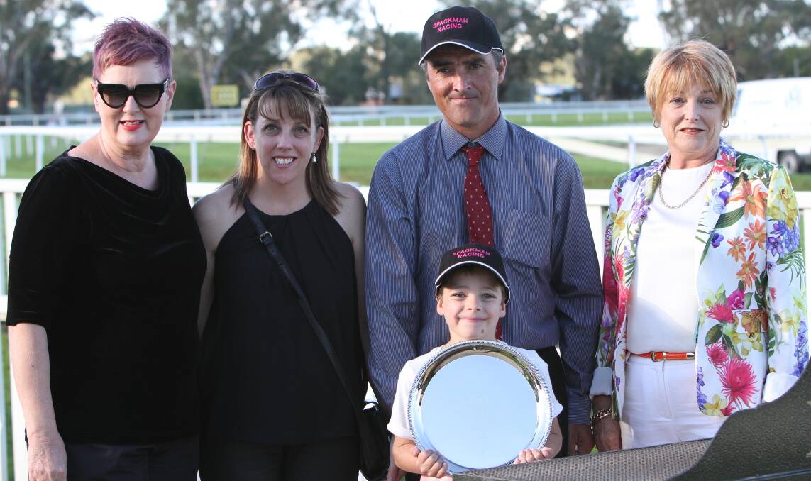 SPECIAL MOMENT: Lyn Irvin-Day (far left) and Anne Taylor (far right) present the trophy for the John Clark 2014 Town Plate Prelude to winning connections Scott and Donna Spackman and their child Oliver at the Murrumbidgee Turf Club on Sunday. Picture: Laura Hardwick