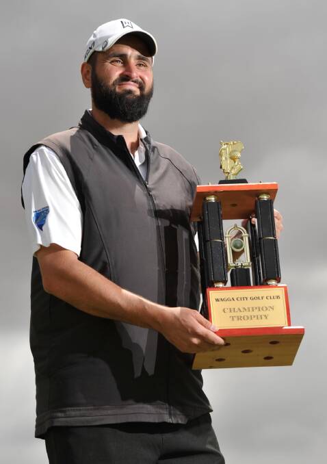 VICTORY: Brett Bishop shows off the trophy after claiming a thrilling victory in the Wagga City Golf Club championships on Sunday. Picture: Michael Frogley