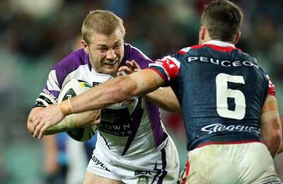 LOCAL HERO: Temora's own Ryan Hinchcliffe takes on Sydney Roosters' James Moloney in an NRL clash last year. Hinchcliffe will be in action for the Storm in the trial against Canberra Raiders in Griffith on Saturday night.
