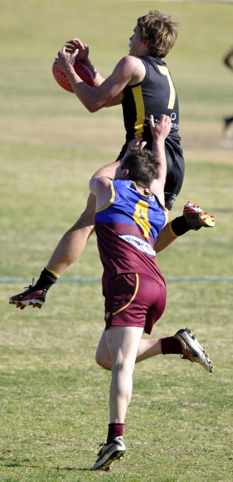 TOO GOOD: Wagga Tigers player Charlie Bance leads Ganmain-Grong Grong-Matong's Jayden Kotzur to the football during Sunday's elimination final at Narrandera Sportsground. Picture: Les Smith