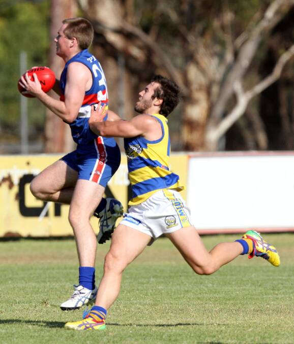 INJURED: Turvey Park defender Brendan Bryce, pictured taking a mark against Mangoplah-Cookardinia United-Eastlakes' Guy Ward last year, is the latest to join the Bulldogs' injury list. 