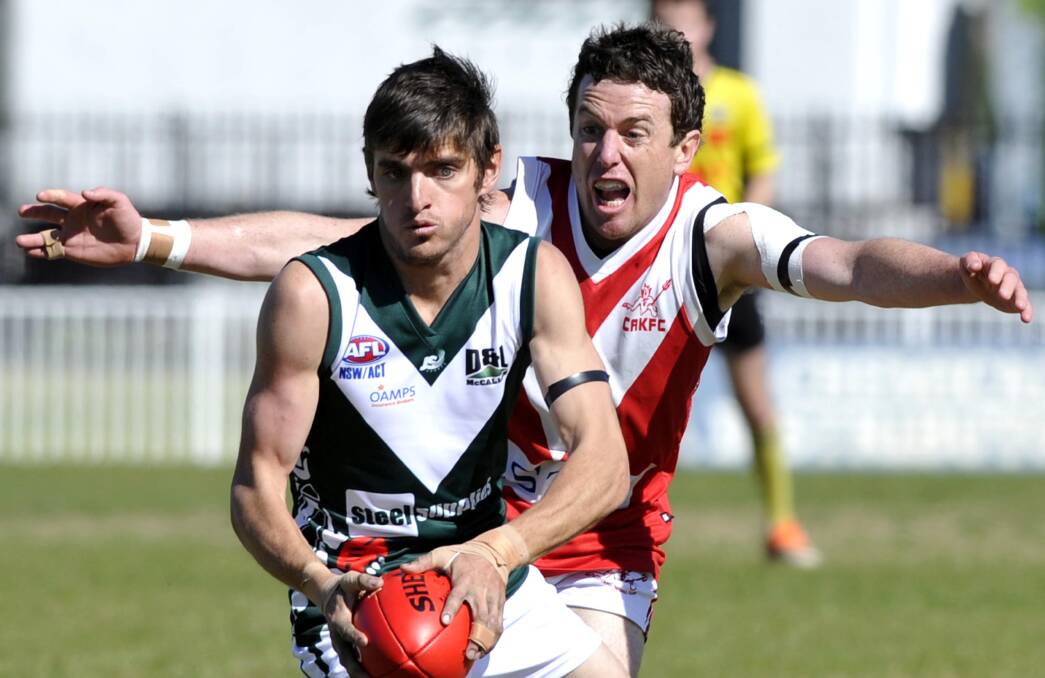 GONE: Collingullie-Ashmont-Kapooka's Chris Gow steams in to crunch Coolamon's Mark Crawford in Sunday's Riverina Football League preliminary final at Robertson Oval. Picture: Les Smith