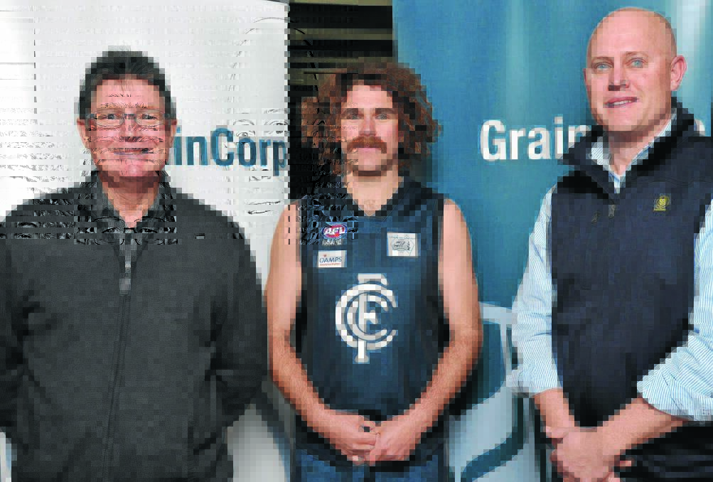 INAUGURAL WINNER: AFL Riverina board member Paul Habel (left) and Graincorp Southern NSW operations manager Warwick Smith congratulate Coleambally midfielder Drew Kenna for taking out the Farrer League player of the year award. Picture: Michael Frogley