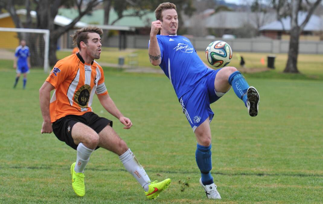 MAN OF THE MOMENT: Tolland's Lachlan Bushby looks to get boot to ball as Wagga United's Chris McKenzie follows closely behind in the Football Wagga top of the table clash at Rawlings Park on Sunday. Picture: Laura Hardwick