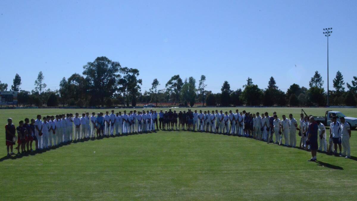 UNITED FRONT: Players pause for a minute of silence before the start of the NSW Country Championships at Exies Oval in Griffith on Friday. Picture: Monique Patterson