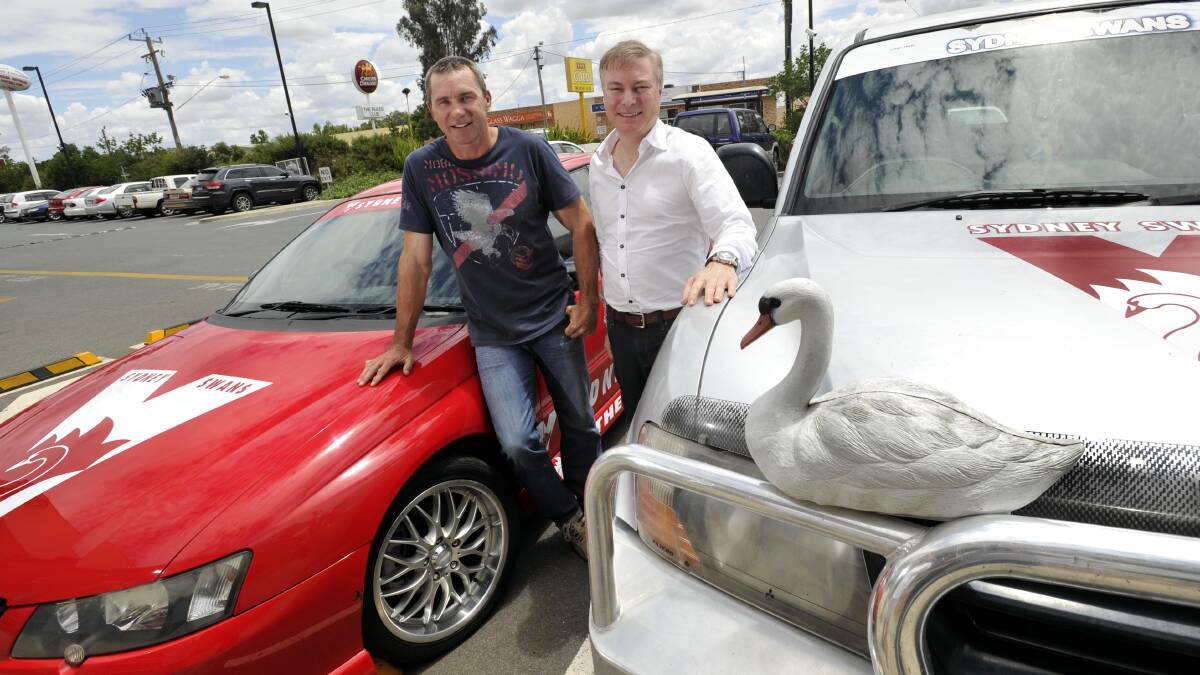 SWANS TERRITORY: Sydney Swans legend Paul Kelly and chairman Andrew Pridham check out some of the cars at the Wagga Sydney Swans Supporters Group Christmas luncheon at the Rules Club on Sunday. Picture: Les Smith