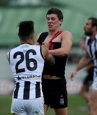 LIFELINE: Leeton's Kurt Aylett wrestles with Collingwood's Marley Williams in a VFL game this season. Aylett has been delisted by the Bombers but is set to be re-drafted in next month's rookie draft.