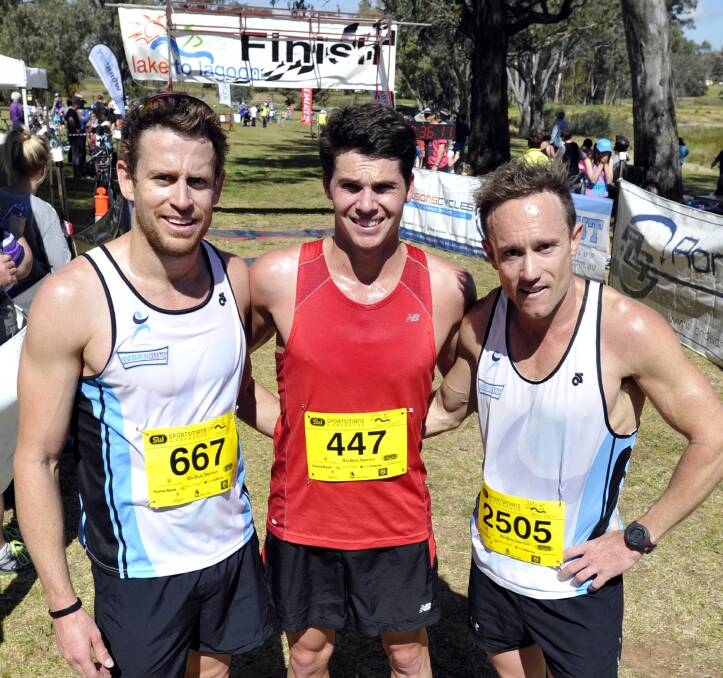 BIG THREE: Lake To Lagoon Fun Run winner James Davy (middle) is flanked by runner-up Jared Kahlefeldt (left) and third-placed Ryan Miller after the finish of yesterday's great event. Pictures: Les Smith