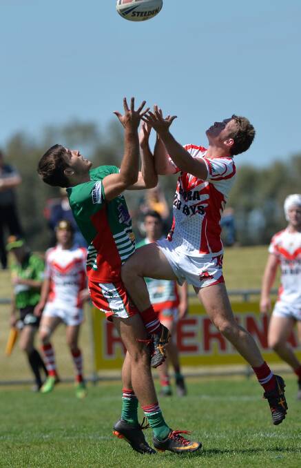 HIGH FLIER: Temora halfback Brady Oliver (right) and Brothers fullback Ed Ansell  contest a bomb in the Weissel Cup grand final in September 