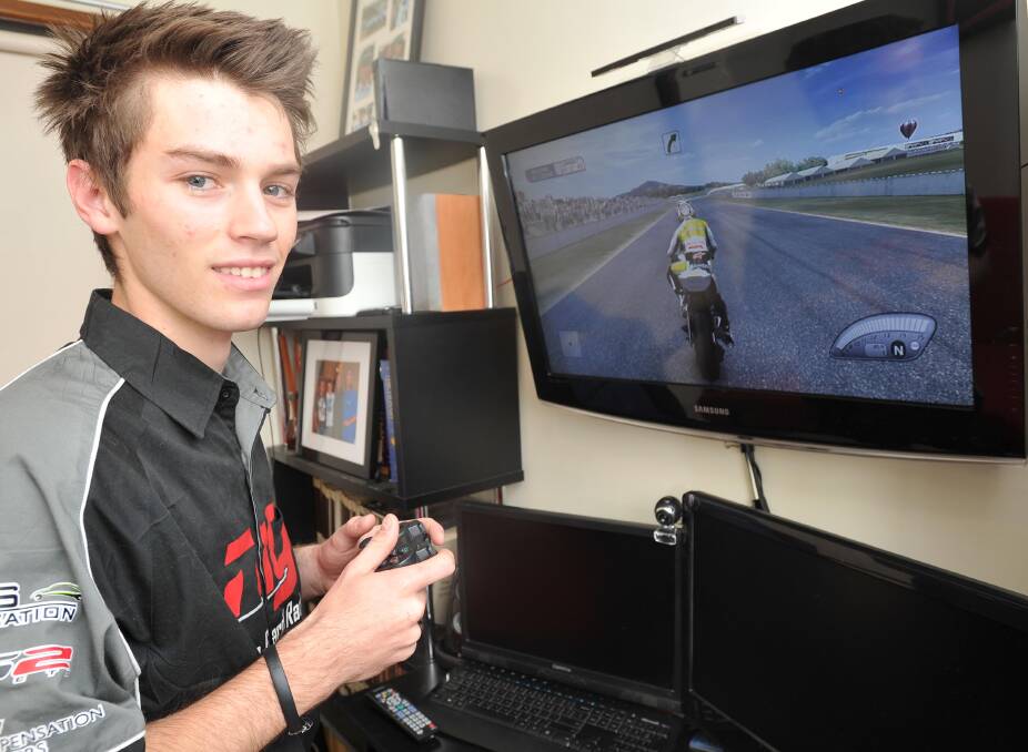 PRACTICE SESSION: Wagga motorbike rider Brandon Demmery at the controls of the PlayStation at his parent's Wagga home yesterday. Picture: Laura Hardwick