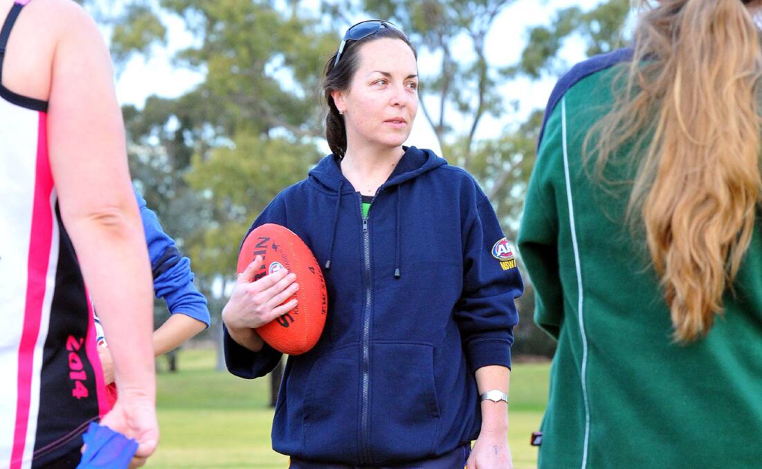 CENTRE OF ATTENTION: Mel Hyland talks to junior players at training at Bolton Park in Wagga this week. On Saturday, Hyland will join select company by playing her 300th game of Australian football