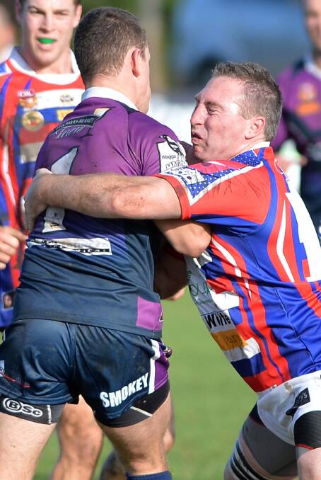 ACTION STATIONS: Young captain-coach Luke Branighan tackles Southcity fullback Scott Bowden at Harris Park yesterday. Branighan was later sin-binned when the Bulls scored two late tries to pull off a 24-22 victory. Picture: Michael Frogley