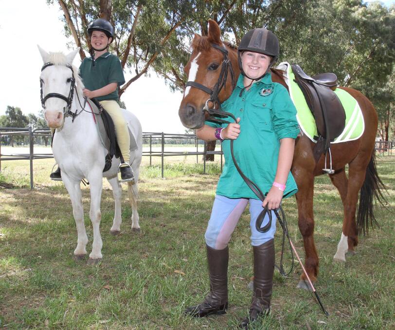 WAITING GAME: Wagga Bidgee Pony Club members Kaci Cabot, 10, with Smokey and Vienna Scoptt, 11, and Tommy are counting down to taking part in the club's gymkhana on Sunday. Picture: Kieren L Tilly