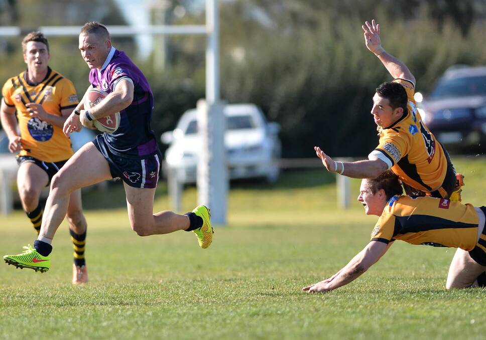 ESCAPE ARTIST: Southcity centre Peter Little blasts past Gundagai defenders Damien Willis and Dane O'Hehir to score one of his solo tries at Harris Park yesterday. Pictures: Michael Frogley
