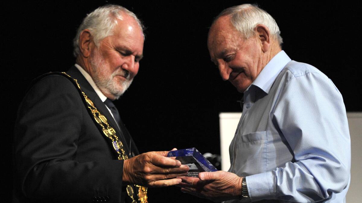 Wagga cycling legend Barry O'Hagan is inducted into the Wagga Sporting Hall of Fame. O'Hagan shows obvious emotion as Wagga mayor Rod Kendall congratulates him on stage at the Wagga Civic Theatre. Picture: Les Smith