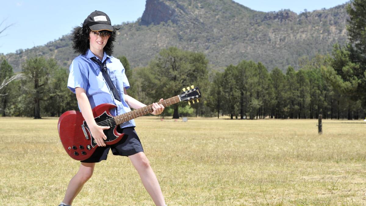LET THERE BE ROCK: The Rock Central School student Riley Campton, 11, channels Angus Young ahead of AC/DC's album launch in The Rock. Picture: Les Smith