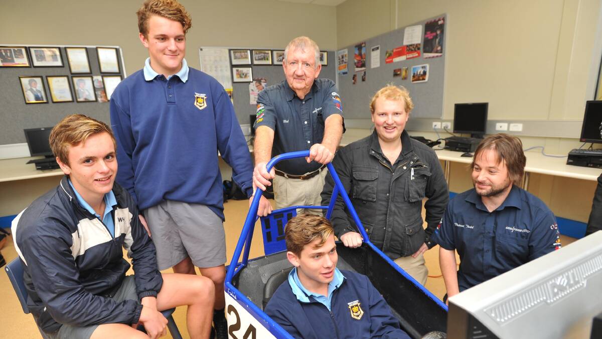 ENGINEERING A FUTURE: University Of Wollongong comes to Wagga to encourage students to follow a career in engineering. Wagga High student Mitch Cawley races an interactive race car, while (back from left) Steve Senior, Matthew Fellows, UOW's Dr Bob Wheway, Wagga High teacher Josh McKenzie and UOW's Todd Demsey watch on. Picture: Laura Hardwick