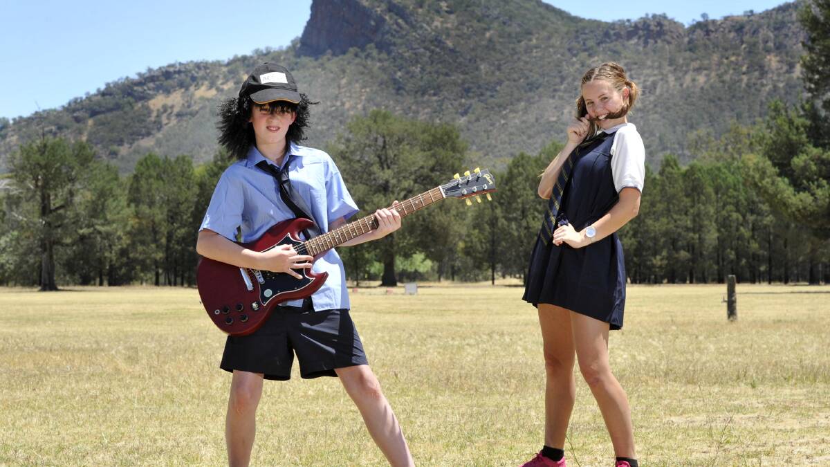 ROCK OR BUST: The Rock Central School students Riley Campton, 11,  and Emily Mitchell, 16, are hit with rock'n'roll fever ahead of the AC/DC album launch. Picture: Les Smith